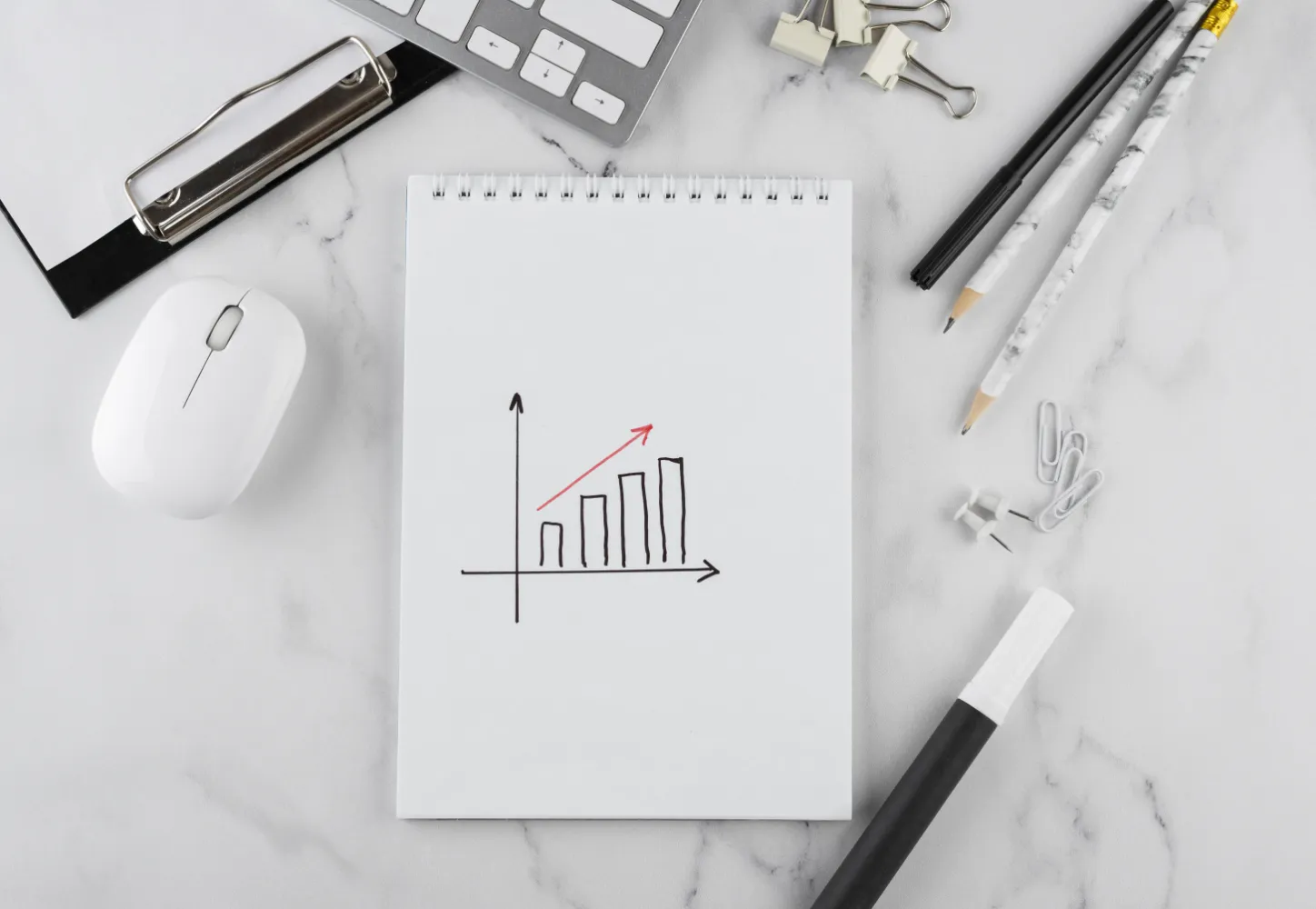 A hand-drawn growth chart on a notepad at a tidy desk